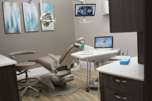Dental treatment room with Planmeca Emerald and Pelton & Crane chair.